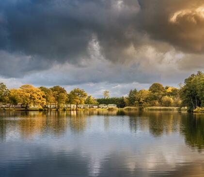 Autumn across the lake at Pearl Lake Country Holiday Park